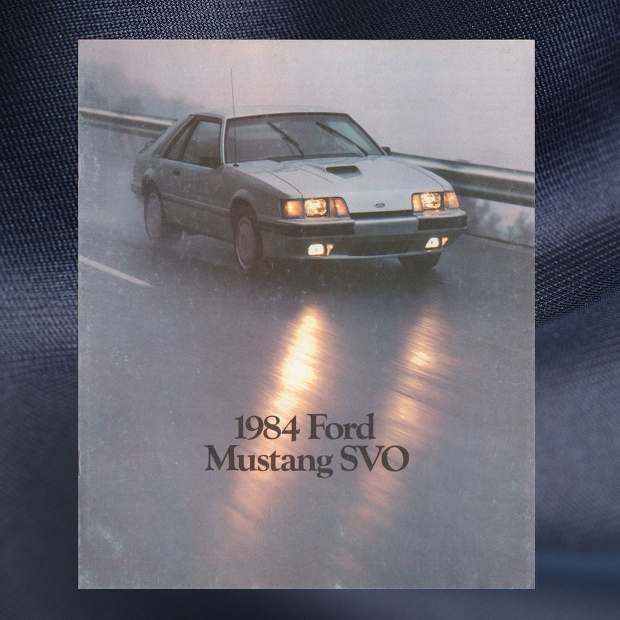 1984 Ford Mustang SVO original dealer sales brochure cover featuring the silver turbocharged Fox-body Mustang