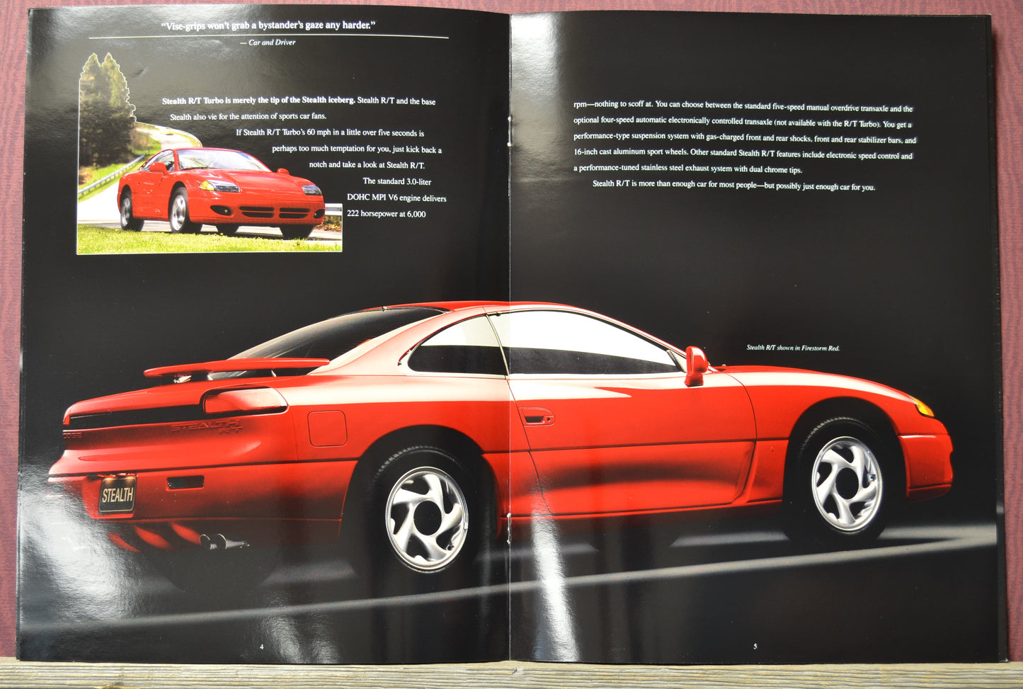 Open book showing a red 1995 Dodge stealth car on a black background with text.