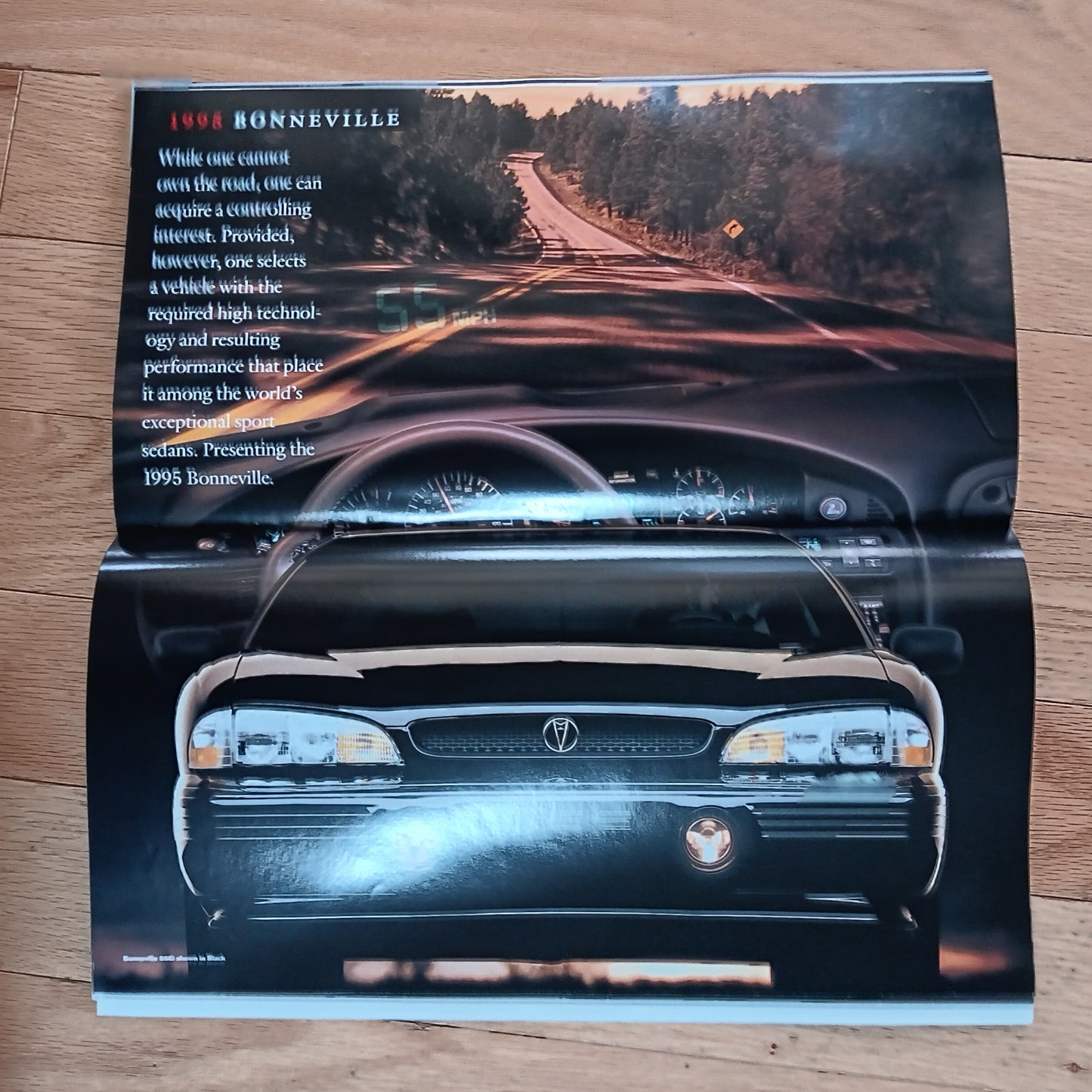 Car brochure for 1998 Bonneville on a wooden surface
