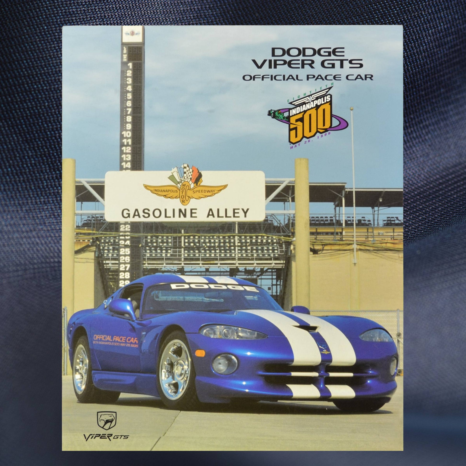 1996 Dodge Viper GTS Indy 500 Pace Car sales flyer cover, featuring the blue and white-striped Viper in front of Gasoline Alley at Indianapolis Motor Speedway.