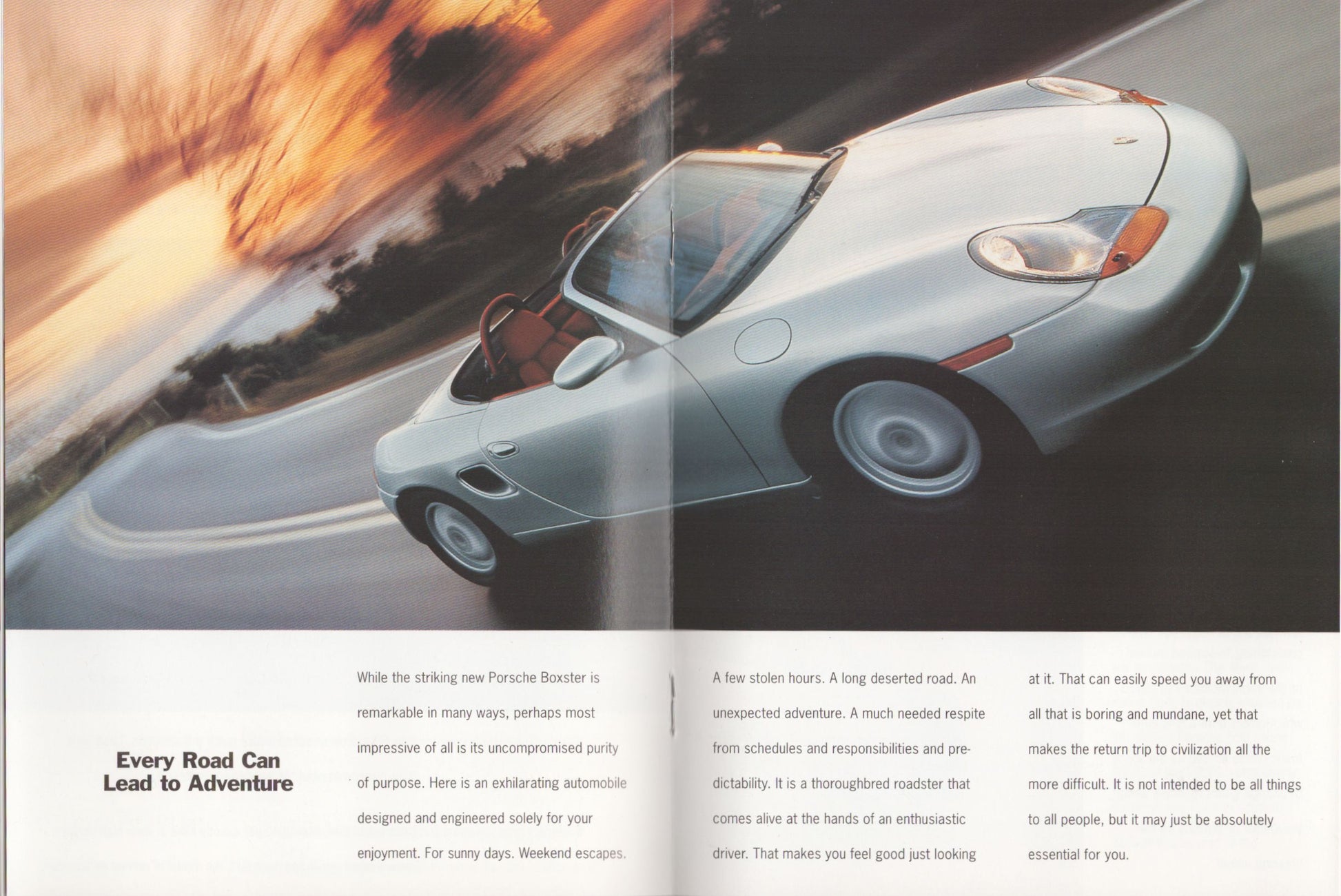 porsche boxster on a road with sunset in the background