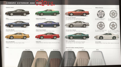 An open catalog or brochure spread showing 1998 Camaro exterior and trim color options, with multiple side-profile car photos, wheel design options, and leather seat surface color samples arranged along the bottom.