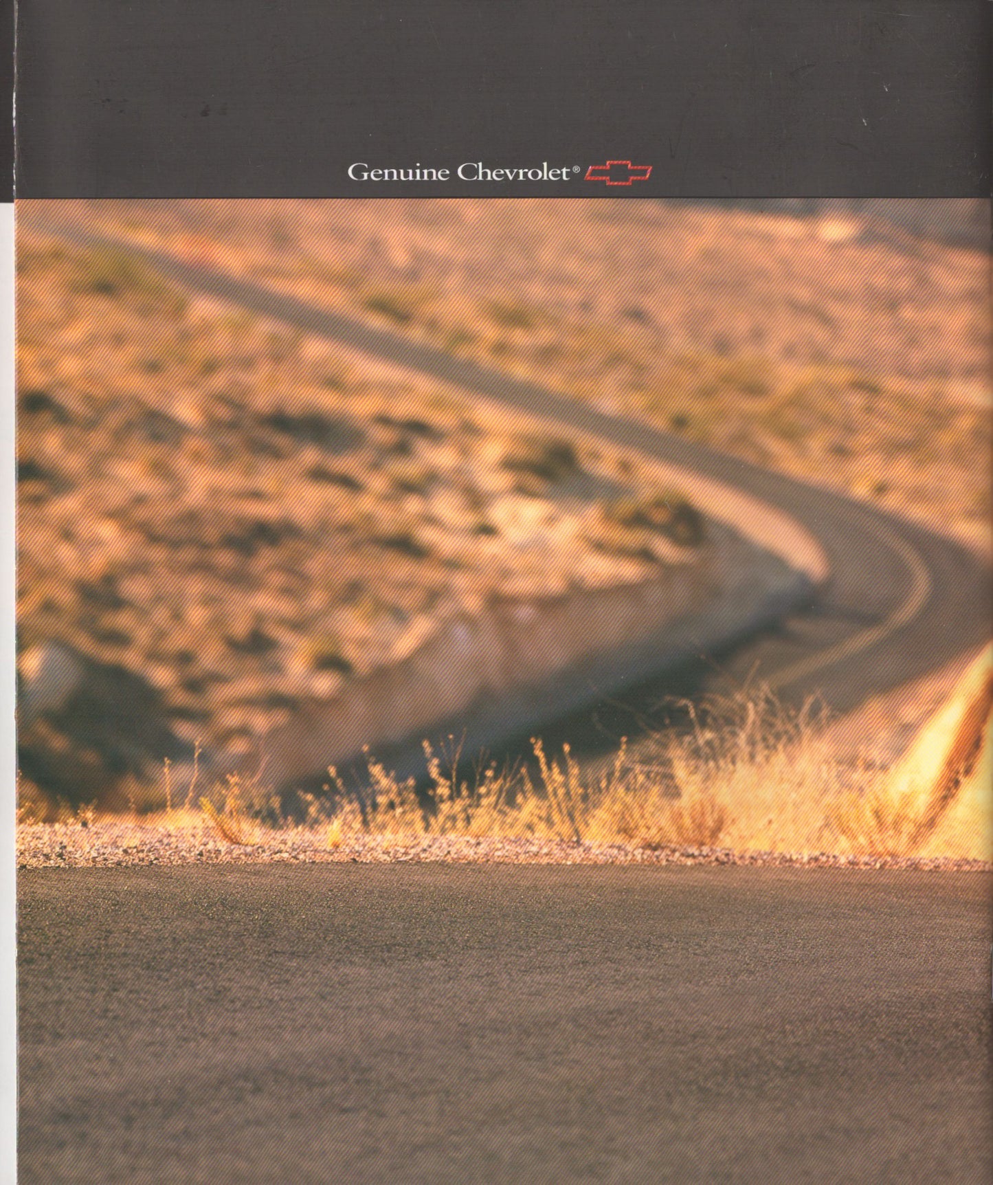 A Genuine Chevrolet branded advertisement or booklet page featuring a winding road through dry, sunlit hills under a dark header with the Chevrolet name and logo.
