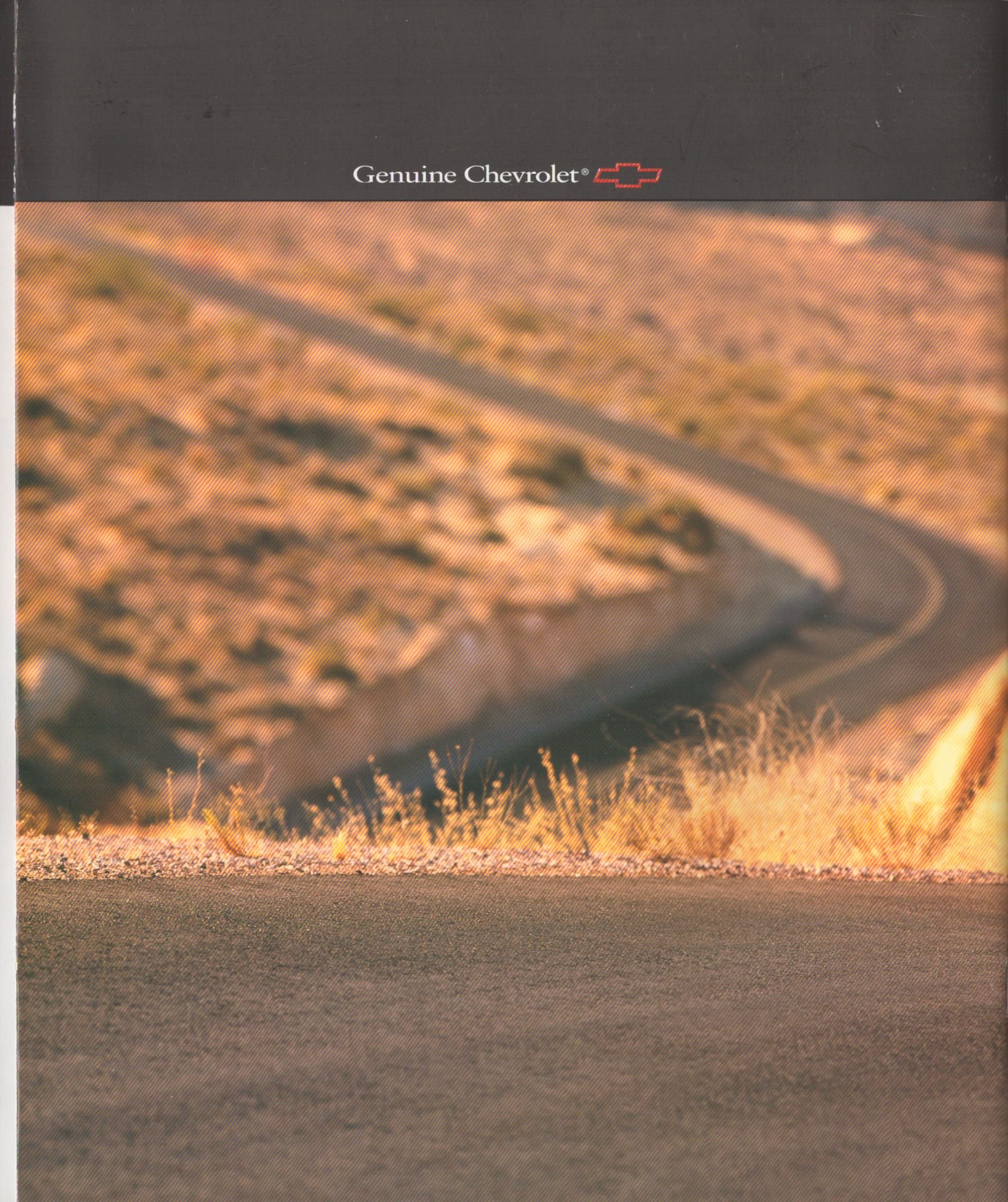 A Genuine Chevrolet branded advertisement or booklet page featuring a winding road through dry, sunlit hills under a dark header with the Chevrolet name and logo.