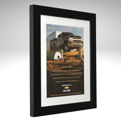 Framed advertisement for Chevrolet Silverado HD truck on a white background