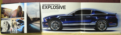 Side profile of blue 2010 Shelby GT500 Mustang with performance specs from vintage Ford catalog – supercharged 540 hp V8

