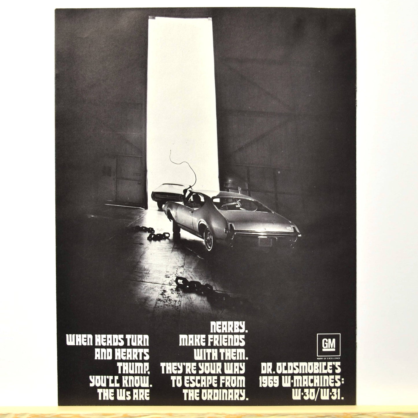 Back cover with 1969 W-Machine exiting garage, tagline “Escape from the ordinary”

