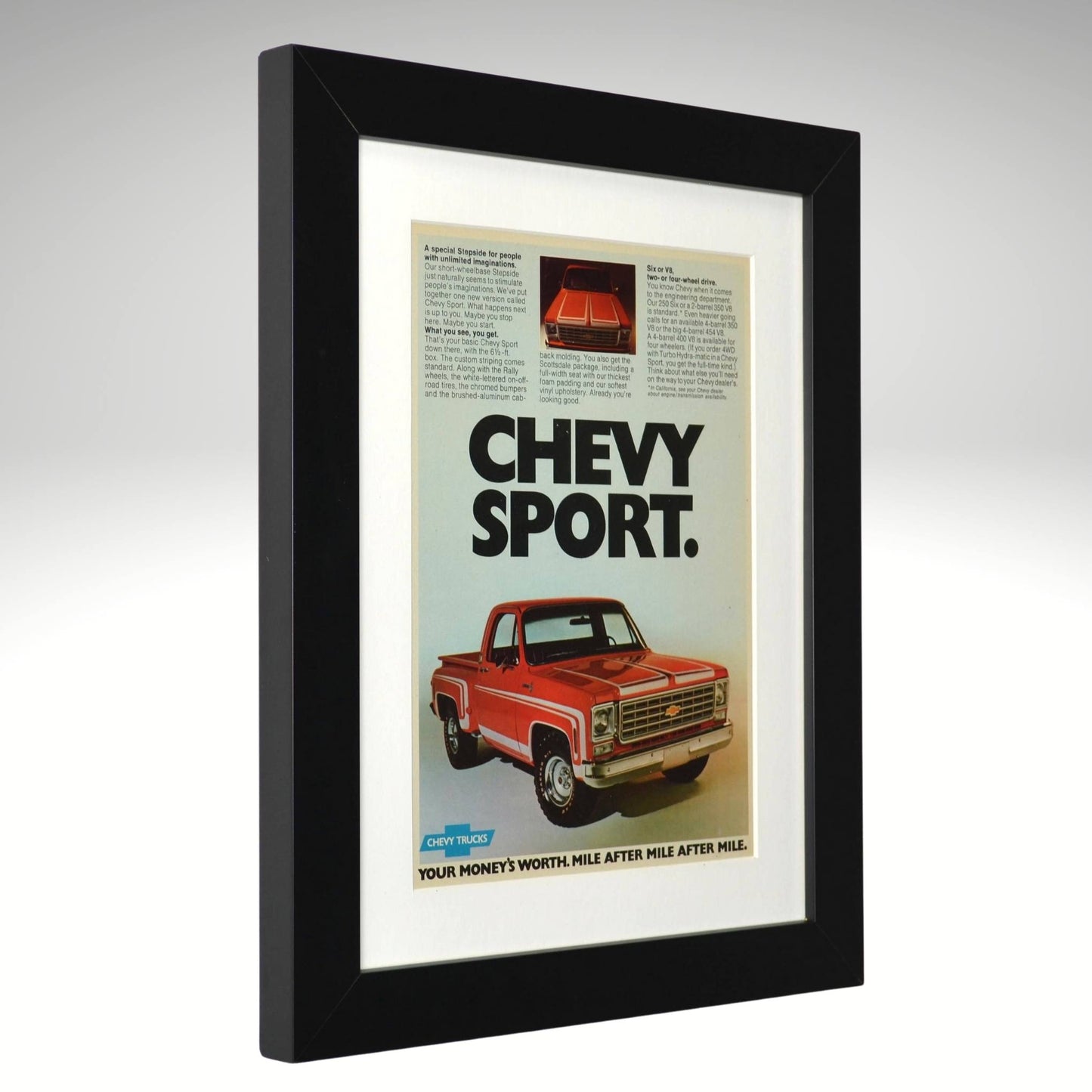 Framed advertisement for a red 1975 Chevrolet truck with 'Chevy Sport' text.