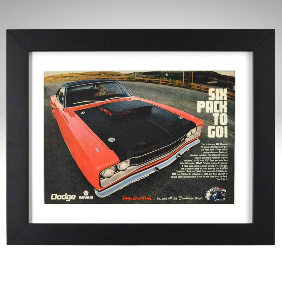 Framed 1970 Dodge Super Bee 440 Six Pack vintage print ad featuring an orange Super Bee with matte black Six Pack hood and “Six Pack to Go!” slogan — authentic Mopar wall art for collectors and enthusiasts