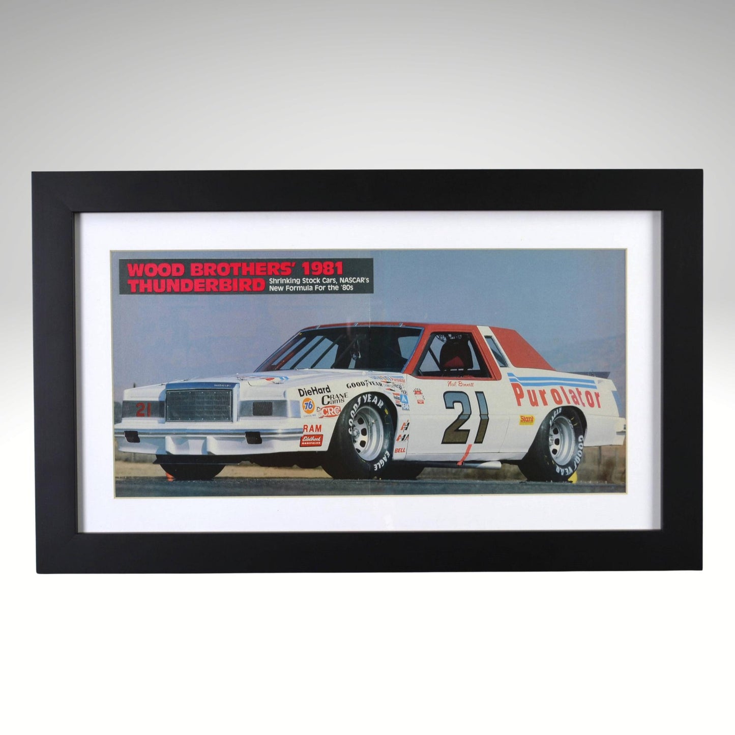 Framed 1981 Wood Brothers NASCAR Thunderbird print showing Neil Bonnett’s No. 21 Purolator Ford in a two-page racing ad, preserved as 12×20 wall art.