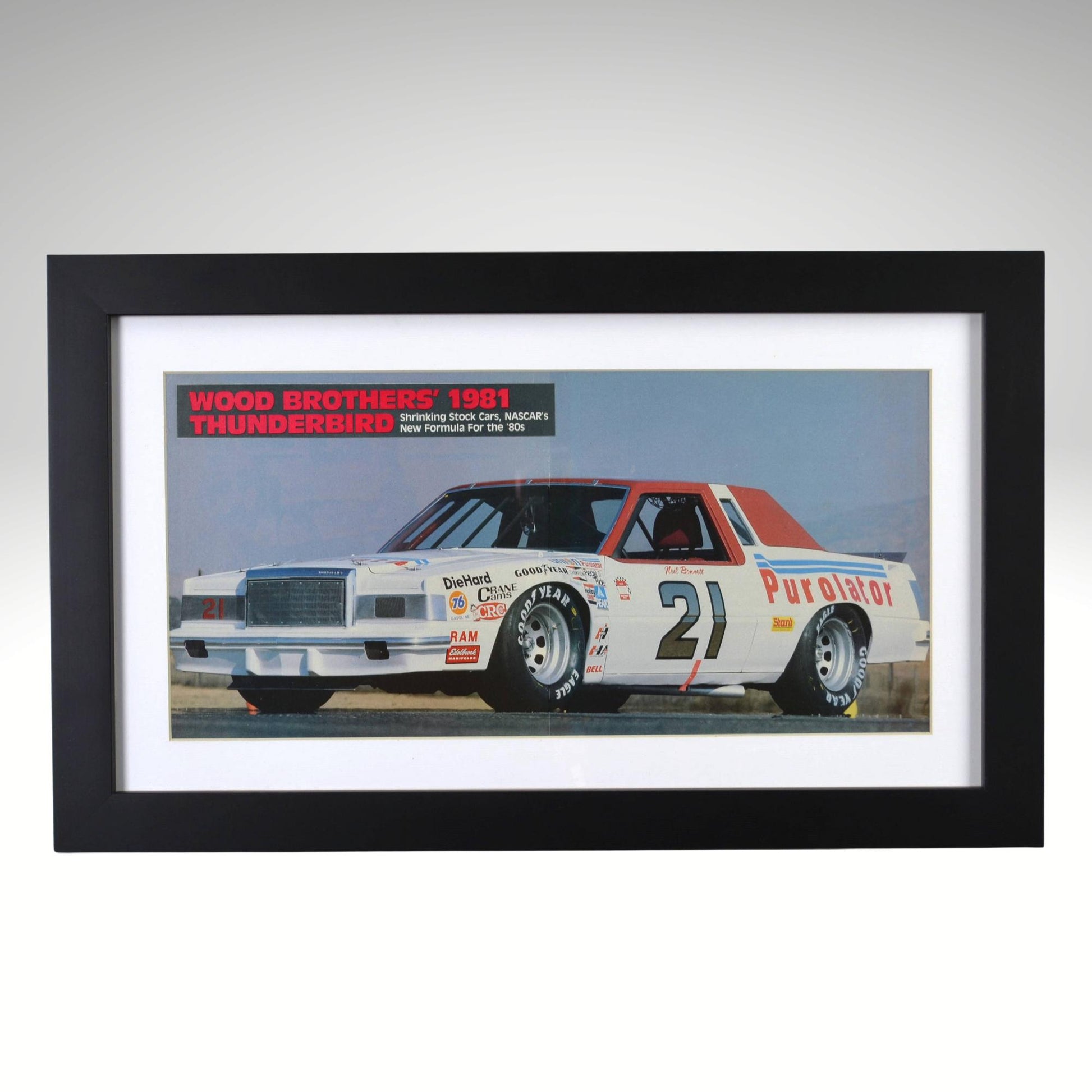 Framed 1981 Wood Brothers NASCAR Thunderbird print showing Neil Bonnett’s No. 21 Purolator Ford in a two-page racing ad, preserved as 12×20 wall art.