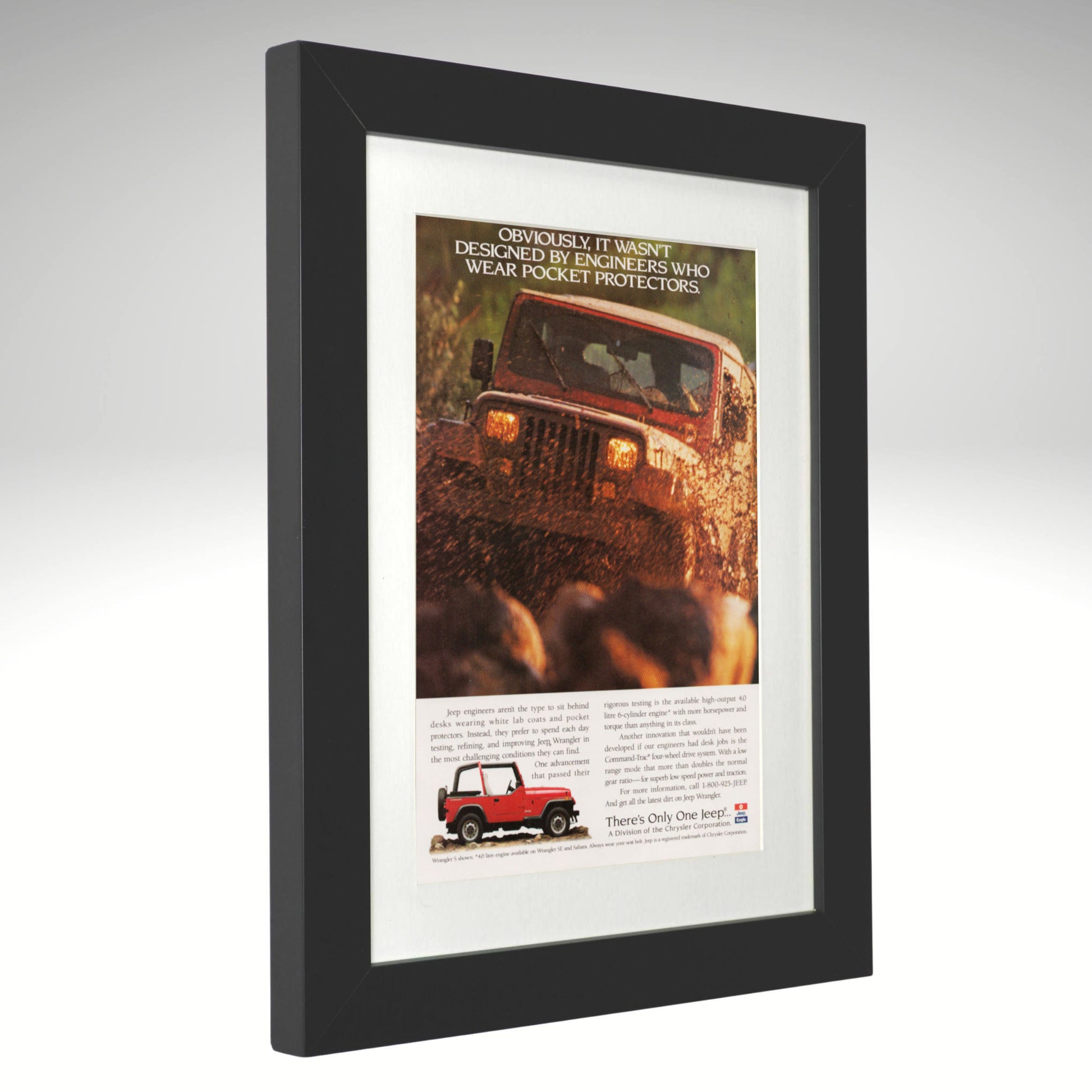 Framed advertisement of a red off-road Jeep wrangler
