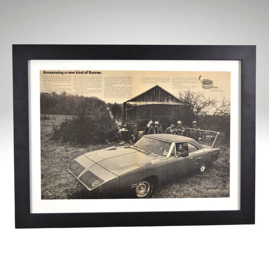 Framed black-and-white print of the 1970 Plymouth Roadrunner Superbird, featuring its aerodynamic design built for NASCAR racing, set against a barn backdrop.