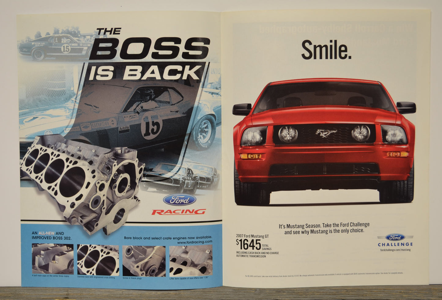 Ford advertisement with a red Mustang and engine parts, featuring text 'The Boss is Back' and 'Smile.'