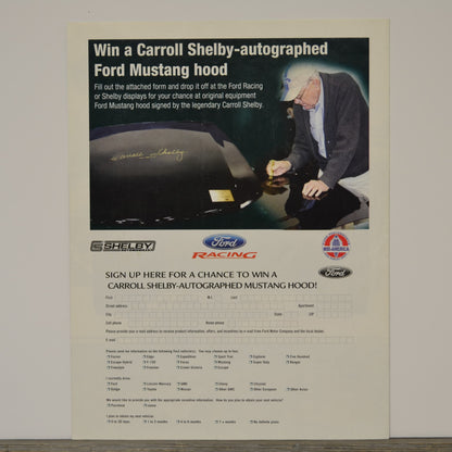 Advertisement for a chance to win a Carroll Shelby-autographed Ford Mustang hood, featuring a man signing the hood.