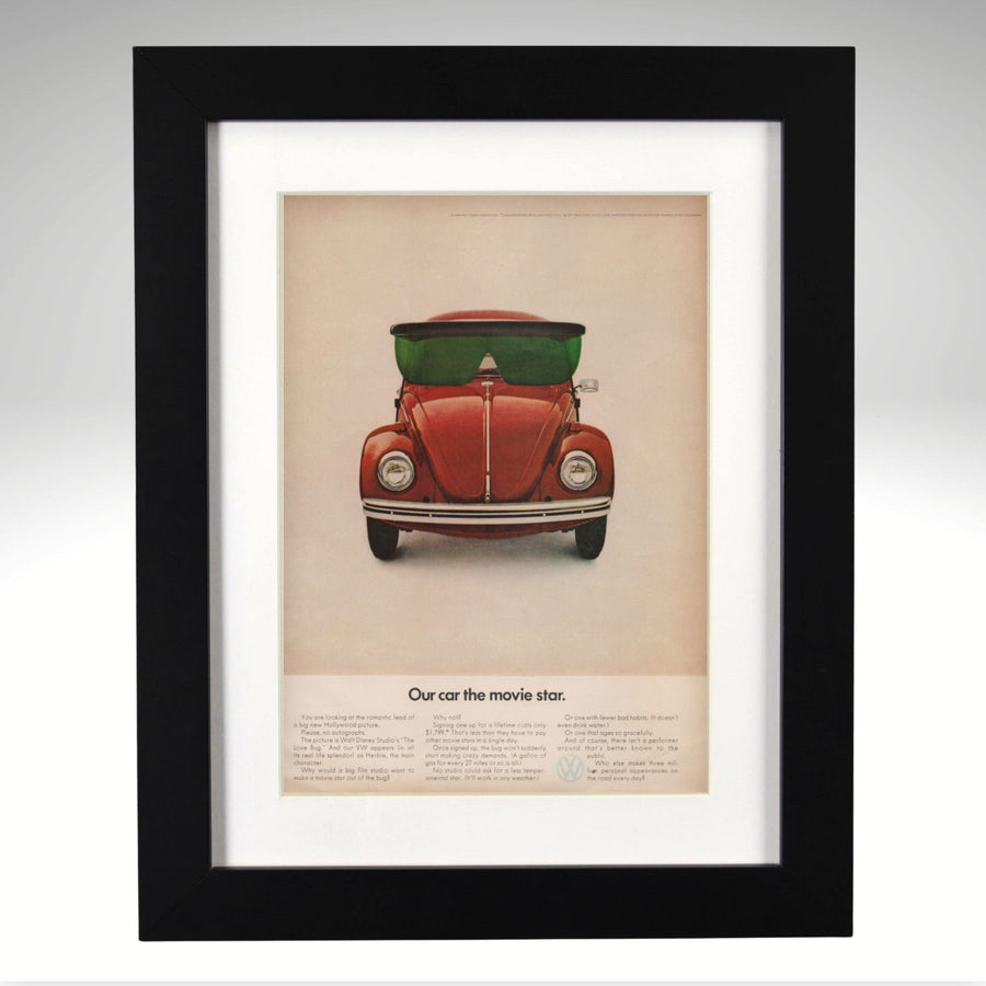 Framed poster of a VW Beetle Disney Movie Star Ad with sunglasses on a beige background