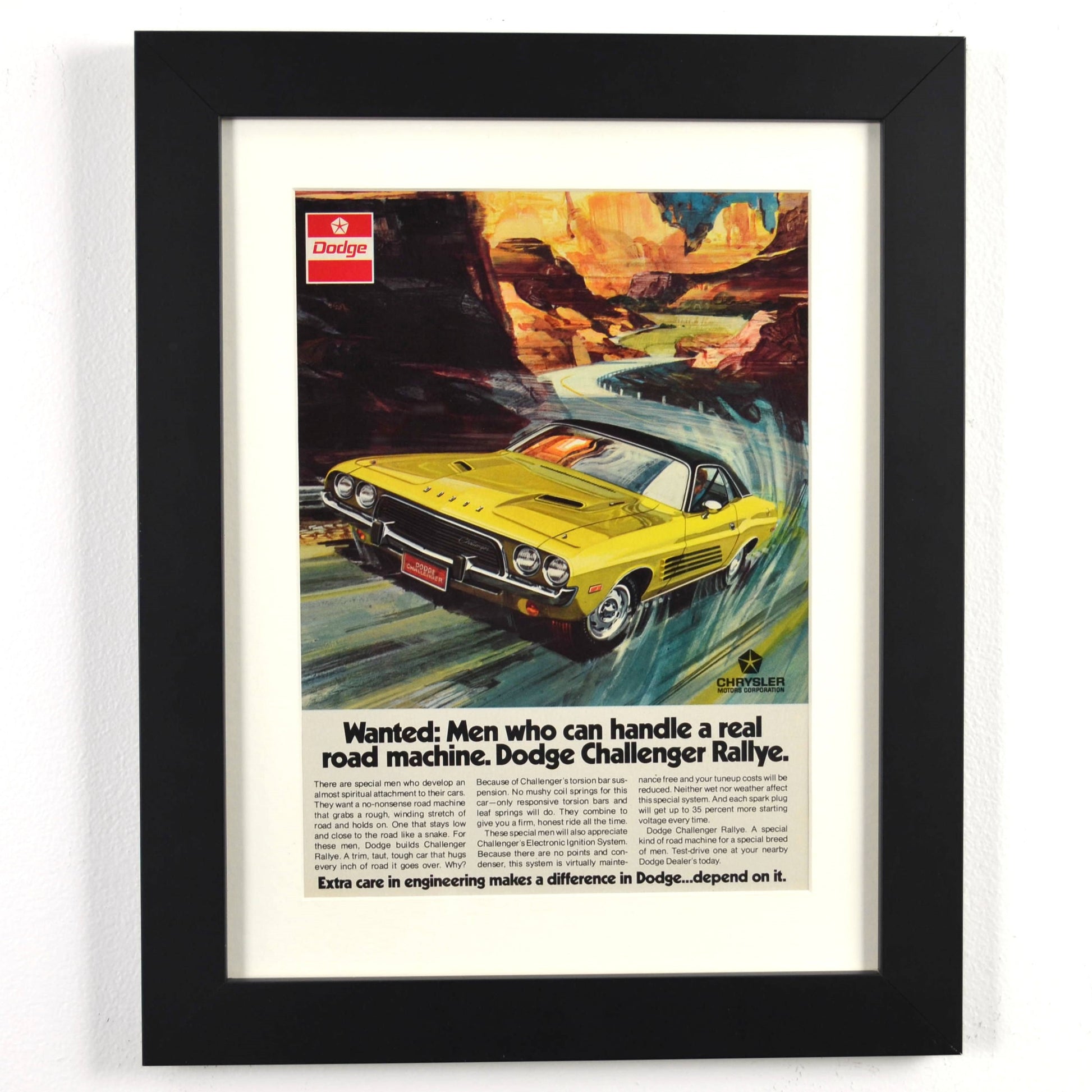 Framed Dodge Challenger Rallye print ad with yellow car and canyon background – vintage Mopar wall art with new frame, mat, and glass
