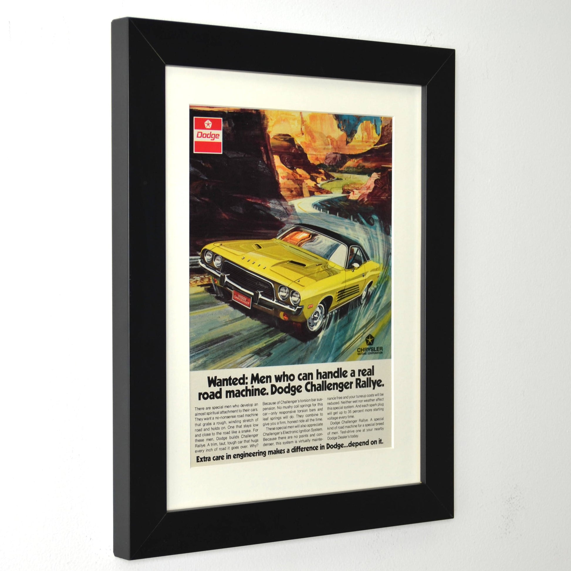 Framed Dodge Challenger Rallye print ad with yellow car and canyon background – vintage Mopar wall art with new frame, mat, and glass side view
