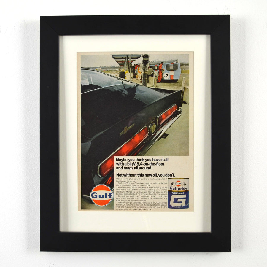 Framed vintage 1967 Gulf Oil print ad featuring a Shelby GT500 Mustang at a Gulf gas station. Professionally dry mounted and displayed in a 10x13 matte black frame with white matting, showcasing Gulfpride Formula G motor oil branding