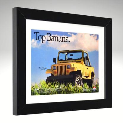 Framed advertisement of a yellow Jeep Wrangler with 'Top Banana' text on a gray background