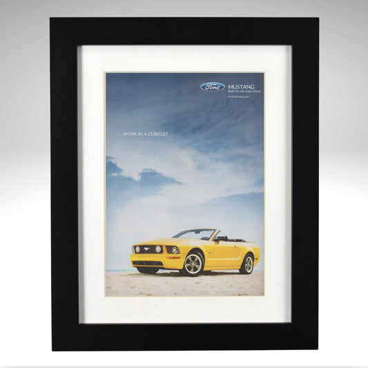 Framed poster of a yellow Ford Mustang convertible against a blue sky with clouds.