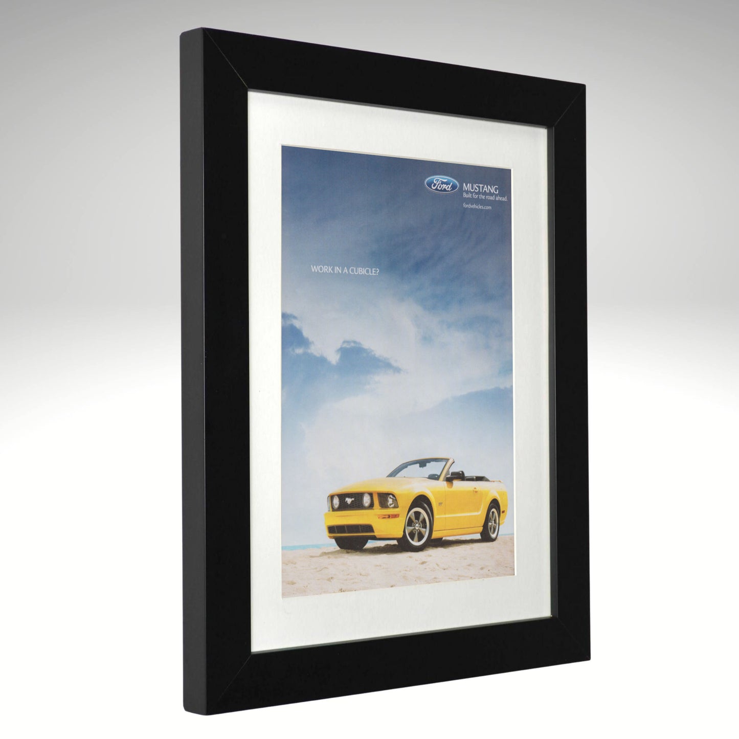 Framed poster of a Mustang GT convertible car on a beach with a black frame.
