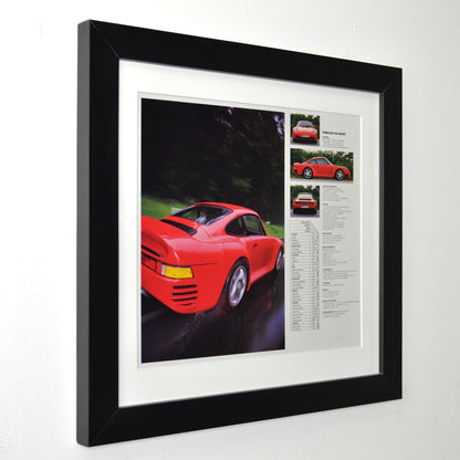 Framed vintage Red Porsche 959 Sport print ad, professionally dry mounted from two pages and displayed in a 13x14 matte black frame with white matting. Features the iconic Porsche 959 supercar in motion, along with performance specs and details side view