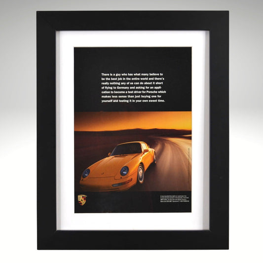 Framed poster of a yellow Porsche 911 Carrera car on a desert road with a quote.